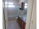 Bathroom featuring double sinks, with tub and glass shower doors at 3930 S Quatar St, Aurora, CO 80018