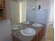 Bathroom vanity featuring double sinks, great lighting, and ample mirror space at 3930 S Quatar St, Aurora, CO 80018