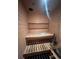 Interior view of a wood-paneled sauna with seating and accessories at 3930 S Quatar St, Aurora, CO 80018