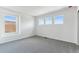 Bright bedroom featuring grey carpeting and multiple windows at 9663 Ceylon St, Commerce City, CO 80022