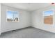 Bedroom with grey carpet and multiple windows at 9663 Ceylon St, Commerce City, CO 80022