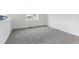 Spacious bedroom with grey carpeting and large window at 9663 Ceylon St, Commerce City, CO 80022