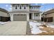 Two-story house with gray siding, attached garage, and small front yard at 9663 Ceylon St, Commerce City, CO 80022