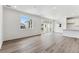 Bright living room with vinyl plank flooring and sliding glass door to backyard at 9663 Ceylon St, Commerce City, CO 80022