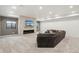 Finished basement with a stone fireplace, large sectional sofa, and modern lighting at 3343 S Newcombe St, Lakewood, CO 80227