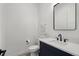 Modern powder room with navy vanity and a sleek mirror at 3343 S Newcombe St, Lakewood, CO 80227