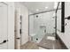 Modern bathroom with a walk-in shower, gray tile, and floating vanity at 3343 S Newcombe St, Lakewood, CO 80227