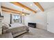 Spacious bedroom with wood beams, large window, and plush carpet at 3343 S Newcombe St, Lakewood, CO 80227