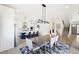 Bright dining area features a large table and modern chandelier at 3343 S Newcombe St, Lakewood, CO 80227