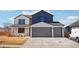 Two-story house with gray and white exterior, two-car garage, and landscaping at 3343 S Newcombe St, Lakewood, CO 80227