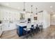 Stylish kitchen with blue island, white cabinets, and modern lighting at 3343 S Newcombe St, Lakewood, CO 80227