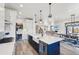 Modern kitchen with large island, white cabinets, and a farmhouse sink at 3343 S Newcombe St, Lakewood, CO 80227