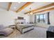 Spacious main bedroom with wood beams and large window at 3343 S Newcombe St, Lakewood, CO 80227