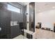 Sleek walk-in shower with dark tile and built-in shelving at 3343 S Newcombe St, Lakewood, CO 80227