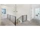 Modern staircase with metal railing and gray carpet at 3343 S Newcombe St, Lakewood, CO 80227