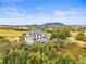 An elevated view shows a house with beautiful landscaping, a pool and mountain views at 1635 Sharps Ct, Castle Rock, CO 80109