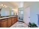 Bathroom featuring double sinks, a walk-in shower, and ample counter space at 1635 Sharps Ct, Castle Rock, CO 80109