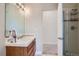 Bathroom featuring a single sink vanity with wooden cabinetry and a glass door shower at 1635 Sharps Ct, Castle Rock, CO 80109