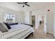 Bedroom with a ceiling fan, a queen bed, and an attached bathroom at 1635 Sharps Ct, Castle Rock, CO 80109