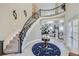 Elegant foyer with curved staircase and designer rug creates a grand entrance at 1635 Sharps Ct, Castle Rock, CO 80109
