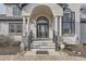 Stately front entrance with arched doorway, elegant columns, and decorative stone accents at 1635 Sharps Ct, Castle Rock, CO 80109