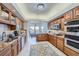 Eat-in kitchen featuring custom cabinetry and a stainless steel oven at 1635 Sharps Ct, Castle Rock, CO 80109