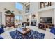 Bright living room with soaring ceilings and stone fireplace at 1635 Sharps Ct, Castle Rock, CO 80109
