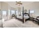 Spacious main bedroom featuring a four-poster bed, a cozy seating area, and bright natural light at 1635 Sharps Ct, Castle Rock, CO 80109