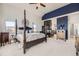 Main bedroom with a luxurious four-poster bed, fireplace, and stylish furnishings at 1635 Sharps Ct, Castle Rock, CO 80109