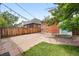 Outdoor stone patio with a wooden fence, string lights and brick building at 3330 W 30Th Ave, Denver, CO 80211