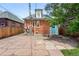 Stone patio and yard feature brick building with trees and wooden fence at 3330 W 30Th Ave, Denver, CO 80211