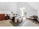 Comfortable bedroom with natural light, wood trim, rug, and a sitting area at 3330 W 30Th Ave, Denver, CO 80211