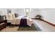 Inviting bedroom with natural light, wood trim, rug, and a sitting area at 3330 W 30Th Ave, Denver, CO 80211