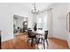 Open dining room with hardwood floors, chandelier, and views to a living room and abundant natural light at 3330 W 30Th Ave, Denver, CO 80211