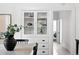 Bright dining area features built-in hutch with glass doors and drawers, offering stylish storage at 3330 W 30Th Ave, Denver, CO 80211