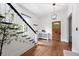 Elegant entryway showcasing a wooden door and staircase with a modern light fixture at 3330 W 30Th Ave, Denver, CO 80211