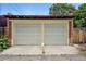 Two-car garage with classic panel doors and a brick facade, providing secure parking at 3330 W 30Th Ave, Denver, CO 80211
