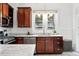 Kitchen features stainless steel appliances, granite countertops, and wood cabinetry at 3330 W 30Th Ave, Denver, CO 80211