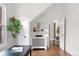 Bright living room features hardwood floors, built-in shelving, and a decorative tree at 3330 W 30Th Ave, Denver, CO 80211