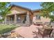 Backyard features stone patio with seating, fire pit, and manicured landscaping at 15637 Deer Mountain Cir, Broomfield, CO 80023