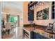 Home wet bar featuring granite countertops and sleek wine fridge at 15637 Deer Mountain Cir, Broomfield, CO 80023