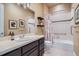 Bathroom with tiled shower-tub, dark cabinet, and neutral walls at 15637 Deer Mountain Cir, Broomfield, CO 80023