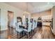 Elegant dining room with a large table, hardwood floors, and an open view to the kitchen area at 15637 Deer Mountain Cir, Broomfield, CO 80023