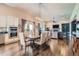 Open concept dining room with wood floors and a modern chandelier at 15637 Deer Mountain Cir, Broomfield, CO 80023
