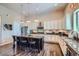 Spacious kitchen with custom cabinets, granite counters, and a central island with seating at 15637 Deer Mountain Cir, Broomfield, CO 80023