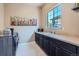 Bright laundry room features a window, sink with counterspace, and modern washer and dryer at 15637 Deer Mountain Cir, Broomfield, CO 80023