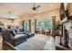 Spacious living room featuring hardwood floors, a stone fireplace, and views of the kitchen area in the background at 15637 Deer Mountain Cir, Broomfield, CO 80023