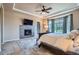 Serene main bedroom with tray ceilings, fireplace, and lots of natural light at 15637 Deer Mountain Cir, Broomfield, CO 80023