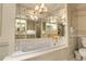 Lovely bathroom with a marble tub, custom cabinets, a makeup vanity, and elegant light fixtures at 1777 Larimer St # 902, Denver, CO 80202