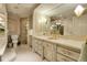 Elegant bathroom with a bright marble vanity, golden faucets, custom white cabinets, and a luxurious shower at 1777 Larimer St # 902, Denver, CO 80202